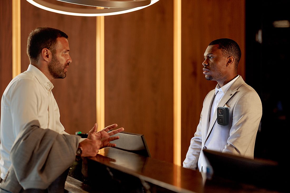 Hotel front-desk staff member wearing a KENWOOD body camera
